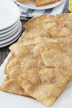 some food is sitting on a plate and next to plates with bread sticks in them