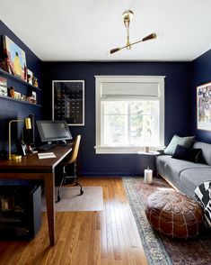 a living room with blue walls and wooden floors