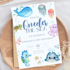 an ocean themed birthday party is set up on a wooden plate with sea animals and jellyfish