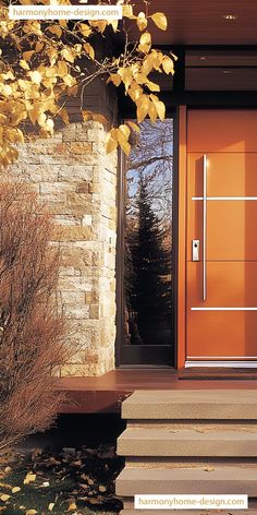 an orange front door with steps leading up to it