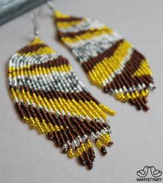 These shining yellow evening earrings are made of high-quality Czech beads and strong synthetic thread. They are elegant, fashionable, and highly versatile, suitable for everyday wear. Features: Sterling silver components Color: Yellow, brown, silver. This item is currently in stock. You must be completely satisfied. If you find merchandise unsatisfactory for any reason, return it within 10 days and your money will be refunded without questions. More beaded earrings http://etsy.me/2ycItdb Gerdan Red Chandelier, Animal Print Earrings, Long Gold Earrings, Fringe Earrings, Seed Bead Earrings, Czech Beads, Gorgeous Earrings, Zebra Print, Chandelier Earrings