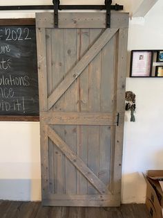 an old barn door is open to show the chalkboard