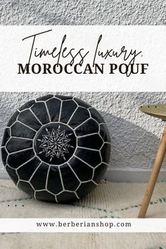 a black and white pouf sitting on top of a rug