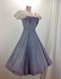 "1950's two-tone party dress in a bluish-gray & cream taffeta with a fitted bodice detailed with soutache embroidery, prong set rhinestones & Pearls . The neckline is an inverted sweetheart shape.. cool yet very sophisticated.. There is a metal zipper that runs up the back of this dress for that perfect hourglass fit. This garment is in EXCELLENT VINTAGE CONDITION. There are a few light watermark spots that are really small here and there.. but nothing distracting. I might have done this Soutache Embroidery, 1950s Party Dresses, Light Purple Dress, 27 Inch Waist, Fashion 50s, Oc Outfits, Mood Clothes, Vintage Dresses 50s, Taffeta Dress