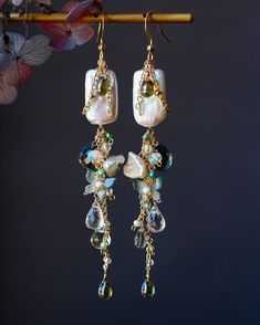 Welcome to visit my Jewelry store:  https://www.etsy.com/shop/Jeansdreamjewelry  Custom order accepted now. Feel free to ask me to see if it is possible. I would love to meet your requirements.  Made to order. Every item will come in a jewelry pouch for safety during travel and gift giving. These dangle earrings are handmade with all natural high quality and well selected gemstones. They are lightweight and comfortable to wear. All materials used are nickel free, friendly to sensitive skin.  🌷MEASUREMENTS Length: 8.8 cm including ear-wire Width: 1.5 cm 🌷GEMSTONE  🔹Dark Green Quartz  🔹White Tone Baroque Pearl 🔹Opal 🔹White Crystal  🔹Czech Lead Glass  🔹Green Crystal  🔹Green Zircon 🌷MATERIALS 🔹14K gold filled ear wire, 14K gold filled wrapping wire, 14K gold filled chain 🌷How to ta Czech Glass Earrings Handmade, Earring Cluster, Garnet Jewelry Set, Dainty Gemstone Jewelry, Red Garnet Jewelry, Czech Jewelry, Kyanite Jewelry, Silk Jewelry, Asymmetrical Earrings