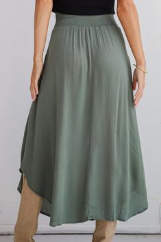 If you have iconic intentions, then the Sensational Purpose Olive Midi Skirt is the perfect look to achieve them! Designed with a flattering high-waisted fit, this skirt gracefully drapes to a midi length, creating a beautiful, flowing silhouette that moves with you. The rich olive hue adds a sophisticated, earthy tone that pairs beautifully with both neutrals and vibrant colors, making it a versatile addition to any closet. Crafted from lightweight, breathable fabric, this skirt offers a soft, High Waist Skirt With Elastic Band, Relaxed High Waist Skirt With Elastic Waistband, High Waist Skirt With Elastic Waistband And Relaxed Fit, High Waist Flowy Lined Skirt, Solid Skirt With Elastic Waistband For Day Out, Rayon Midi Skirt, Chic Rayon Tiered Skirt, Solid Color Flowy Skirted Bottoms, Rayon Tiered Skirt For Day Out