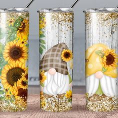 three sunflowers and two gnomes are painted on the side of this tumble cup