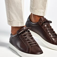 Crafted from supple calf leather, these brown sneakers feature a light brown leather lining and a white herringbone rubber sole. Waistcoat Designs, Brown Gloves, White Herringbone, Light Brown Leather, Wool Flannel, Brown Sneakers, Vest Coat, Brown Belt, Suits Coats