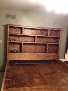 a wooden bed frame sitting on top of a hard wood floor