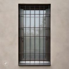 a window with bars on the side of it