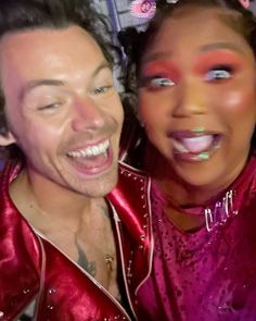 a man and woman posing for the camera with their faces painted like they are smiling