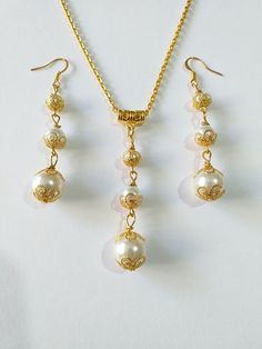 Gold pearl Victorian jewelry set Wedding gold set necklace earrings gold Boho jewelry set Bridal pearl jewelry set Gift pearl set earrings Beautiful Set of gold tone filigree ornaments and white crystal pearl's beads and glass pearl beads pendant necklace and earrings. Antique style filigree gold tone set necklace and earrings . Gold tone glass pearls Bohemian necklace and earrings . Boho necklace . Boho jewelry set . Boho pearl earrings . Bohemian necklace and earrings . Birthday set  necklace and earrings . Gold-tone Ibiza style jewelry set . Bridal jewelry set. Jewelry set for wedding. Birthday gift set. Wedding pearl jewelry set. Bridal jewelry set. This set is a beautiful Gift for Girlfriend, for sister, for mother,for bridesmaids or Maids of Honor, or for yourself.  Gift jewelry set. Wedding Filigree Jewelry Sets, Wedding Jewelry Sets With Filigree, Elegant Pearl Jewelry With Gold Beads, Elegant Gold Dangle Jewelry Sets, Elegant Gold Bridal Necklace With Pearl Drop, Gold-plated Jewelry Sets With Matching Earrings, Elegant Gold Bridal Necklace With Pearl Pendant, Gold Plated Jewelry Sets With Matching Earrings, Elegant Gold Pearl Necklaces