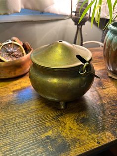 two pots sitting on top of a wooden table