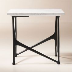 a white marble table with black metal legs