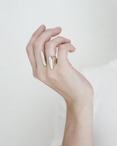 Two offset irregular shaped bars hang from the negative space of the finger creating a floating illusion. Introducing Solids, Solid Gold Jewelry, Timeless Jewelry, Negative Space, Simple Elegance, Recycled Sterling Silver, Organic Shapes, Line Design, Art Director