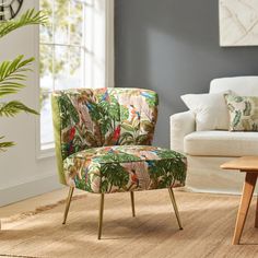 a living room with a chair, table and plants on the floor in front of a window