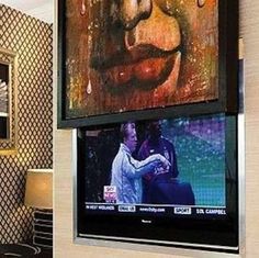 two large televisions mounted to the side of a wall next to each other in a living room