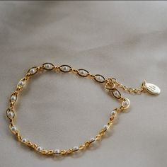 Our Pippa Pearl Bracelet is dainty + modern! What do we love about it? The tiny pearl accents add just a touch of traditional style in a modern way! This bracelet is perfect for any bridal event but can also be worn any time of the year or for any occasion which makes this the perfect gift! BRACELET FEATURES Materials: Brass, 14K Gold, Rhodium, Faux Pearl Finish: Choice of Yellow Gold or Rhodium Plating Dimensions: 6.5" with a 2" extender (can be worn up to 8.5") 14K gold-filled or sterling silv Elegant Pearl Chain Bracelet With Pearl Drop, Elegant White Chain Bracelet With Pearl Charm, Classic White Chain Bracelet With Pearl Drop, Elegant White Chain Bracelet With Pearl Drop, Formal Pearl Charm Chain Bracelet, Elegant Adjustable Chain Bracelet With Pearl Charm, Classic Pearl Charm Chain Bracelet For Wedding, Elegant Adjustable Pearl Charm Chain Bracelet, Feminine Pearl Bracelets With Pearl Charm