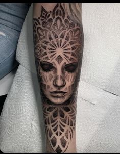 a woman's face with an intricate design on her arm