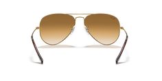 Discover the meticulous craftsmanship that unites style and optical functionality in Ray-Ban Aviator Gradient sunglasses. These pilot-shaped glasses feature a polished gold metal frame that exudes timeless elegance. The gradient light brown lenses add a touch of sophistication and enhance your visual experience, making these shades an ideal choice for everyday wear. Embrace the iconic style of Ray-Ban with these sunglasses. Available with prescription lenses. Classic Gold Aviator Sunglasses With Mirrored Lenses, Classic Gold Polarized Aviator Sunglasses, Classic Gold Aviator Sunglasses With Polarized Lenses, Gold Rimless Sunglasses With Uva Protection, Gold Rimless Polarized Aviator Sunglasses, Gold Aviator Sunglasses With Gradient Lenses For Formal, Gold Rimless Aviator Sunglasses With Uv Protection, Gold Rimless Aviator Sunglasses With Polarized Lenses, Elegant Gold Aviator Sunglasses With Uva Protection