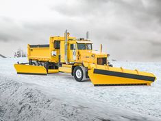 a snow plow truck parked on the side of a road