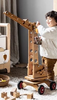 a child playing with wooden toys in a room