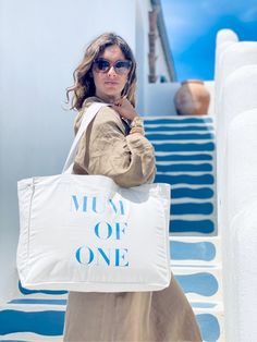 a woman carrying a large white tote bag