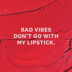 a red wall with the words bad vibes don't go with my lipstick