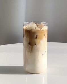 there is a drink with ice in the glass on the white counter top and it looks like something out of space