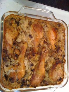 a casserole dish with chicken and rice in it on a stovetop top