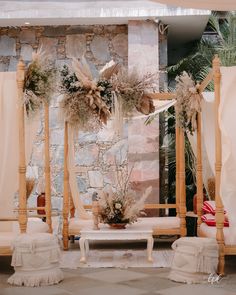 an outdoor wedding setup with flowers and greenery