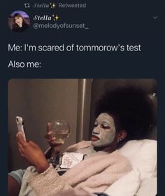 a person with face paint on taking a selfie while holding a glass of wine