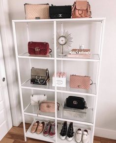 a white shelf filled with purses and handbags