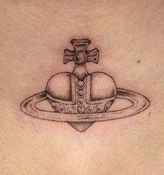 a cross and two hearts on top of a saturn tattoo