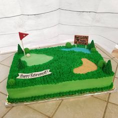 a golf themed birthday cake with green grass and a hole in the ground on top