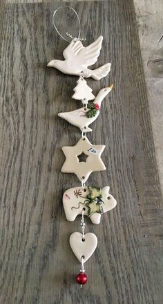 an ornament is hanging on the side of a wooden table with doves and stars