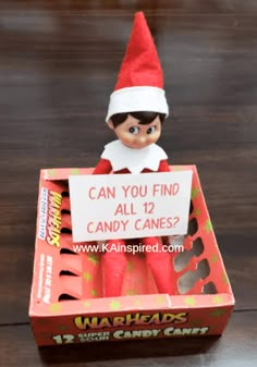 an elf with a sign that says can you find all 12 candy canes?