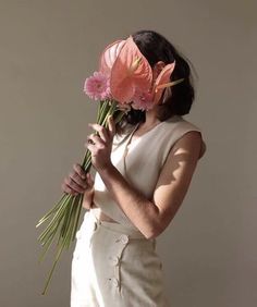 a woman holding flowers in her hands