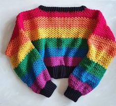 a colorful knitted sweater on a white surface