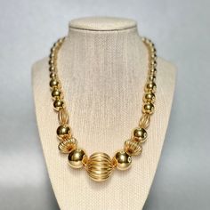 "Vintage Napier Spherical Beads Choker, Gold Tone Graduated Chunky Large Beads Necklace, Mid Century Modern Estate Jewelry, Gifts for Her. Era: Around 1955. Designer: Napier. Measurements: - Length:19\" inches. - Width: 3/8 to 1 3/4\" inches. Details: -Metal Color: Gold Tone - Embellishments: Gold Tone Plating, Chunky Spherical Beads, Graduated Necklace. - Closure: Fold over clasp. Here are more Vintage Jewelry items for your viewing pleasure: https://etsy.me/2SGhTFo Our shop team members do our Modern Estate, Necklace Closure, Large Bead Necklace, Beads Choker, Mid Century Pendant, Large Beads, Choker Gold, Graduation Necklace, Team Members