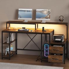 a computer desk with two computers on it