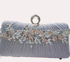 Fabulous design with a glittering touch.  Perfect finishing touch for any formal outfit.  Ideal for cocktail party or wedding.  Can be made in silver, gold or black. Silver Glamorous Evening Bag For Party, Glamorous Party Clutch With Bling, Elegant Evening Bag With Bling For Parties, Elegant Bling Evening Bag For Parties, Elegant Rectangular Sequin Clutch, Glamorous Bling Evening Bag For Party, Glamorous Wedding Clutch For Party Season, Embellished Party Clutch Evening Bag, Party Clutch With Rhinestones