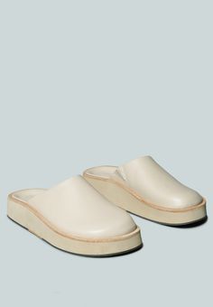 a pair of white slippers sitting on top of each other