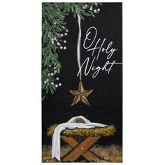 a christmas card with a nativity scene and star on the top, hanging from a tree branch