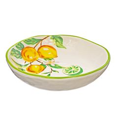 a bowl with lemons and leaves painted on the side, sitting in front of a white background