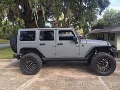 a gray jeep parked in front of a house