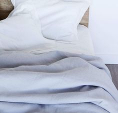 detail of 100% linen bed duvet comforter cover smooth texture lightweight linen fabric pure white color