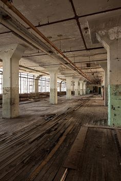 an empty building with lots of wood floors