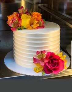 there is a white cake with flowers on it