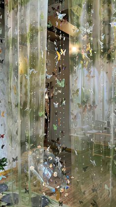 a room filled with lots of butterflies flying through the air